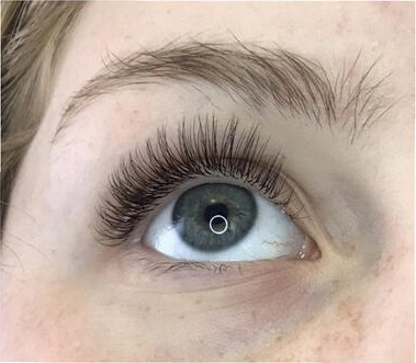 Close-up of lash extensions on a client with blue eyes